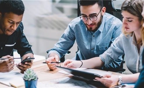 Business people gathered around table talking