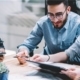 4 things your IT support provider should be doing for you 2 - Square3: NEW NAME. SAME GREAT SERVICE. Business people gathered around table talking